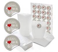 24 bolsas de papel pequeñas blancas con base de papel de regalo de 14 x 22 x 5,6 cm + 24 pegatinas redondas con texto en alemán "Schön dass du da bist" en gris con corazón rojo para envolver adorables