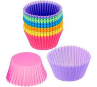 A set of 18 round silicone cake molds, various colors