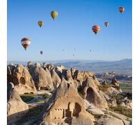 adrium Cuadro de madera de 110 x 110 cm: salas talladas a mano en formación de roca inusual en Goreme, Cappadocia, Turkey. Hot air ballooning in morning is most amazing attract (60469002)