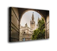 INGENIA HOME Cuadro lienzo canvas Vista de la Giralda de Sevilla desde una puerta abierta antigua Andalucia España - Alta resolución - Varias medidas (80_x_53_cm)