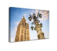 INGENIA HOME Cuadro lienzo canvas Vista la torre de la Giralda de Sevilla y columna con faroles Andalucia España - Alta resolución - Varias medidas (60_x_40_cm)