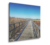 Lienzo decorativo XXL de 70 x 70 cm, diseño de puente de madera a través de las cañas - El camino conduce al infinito color azul
