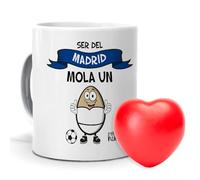 mundohuevo| Taza con frase “Ser del Real Madrid mola un huevo”| Regalo original| Regalo adicional de una pelota antiestrés con forma de corazón de color rojo| Taza de cerámica| Capacidad de 330 ml.