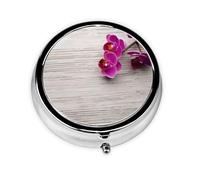 Orchid Este pequeño pastillero redondo impreso es un organizador portátil de píldoras y vitaminas, perfecto para bolsillos, bolsos y viajes.