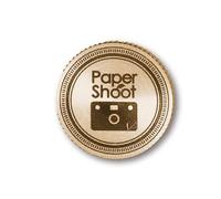 Paper Shoot Tapón de latón LOGO