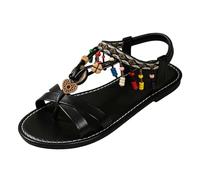 Sandalias genéricas para mujer, sandalias romanas planas entre-dedos con bridas cruzadas colgantes decorativos y detalle bohemio brida trasera elástica suela plana para playa, ocio y vacaciones de