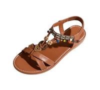 Sandalias genéricas para mujer, sandalias romanas planas entre-dedos con bridas cruzadas colgantes decorativos y detalle bohemio brida trasera elástica suela plana para playa, ocio y vacaciones de