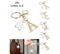 Shein 1 pieza Llavero elegante y premium con letra dorada, colgante 3D con alfabeto de A-Z y dije de flor de cerezo, llavero de aleación de moda, adecuado c