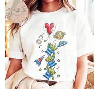 Shein Camiseta Disney Toy Story Aliens | Camiseta con estampado gráfico de aventura espacial dibujado a mano, linda parte superior de manga corta con cohete