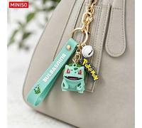Shein MINISO Llavero de Personaje Pokémon Bulbasaur con Etiqueta de Logotipo y Campana para Bolso de Mano, Mochila, Bolso Tote, Regalo de Cumpleaños, Navida