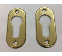 Tachuelas ovaladas para cilindros de perfil europeo. Color latón pulido barnizado para cilindro europeo Orificio Yale.AGB C00640. Medidas: 60 x 28 mm. 2 unidades