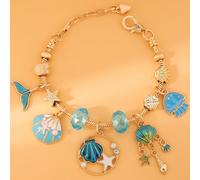 Una pulsera colgante para mujer con del azul, que una de pez, una concha, una medusa y de mar. de acero inoxidable duradero, accesorio de moda es un regalo para ella en de San Valentín